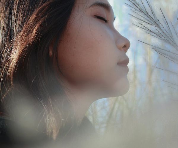 Profile of a person with closed eyes, focusing on calm breathing.